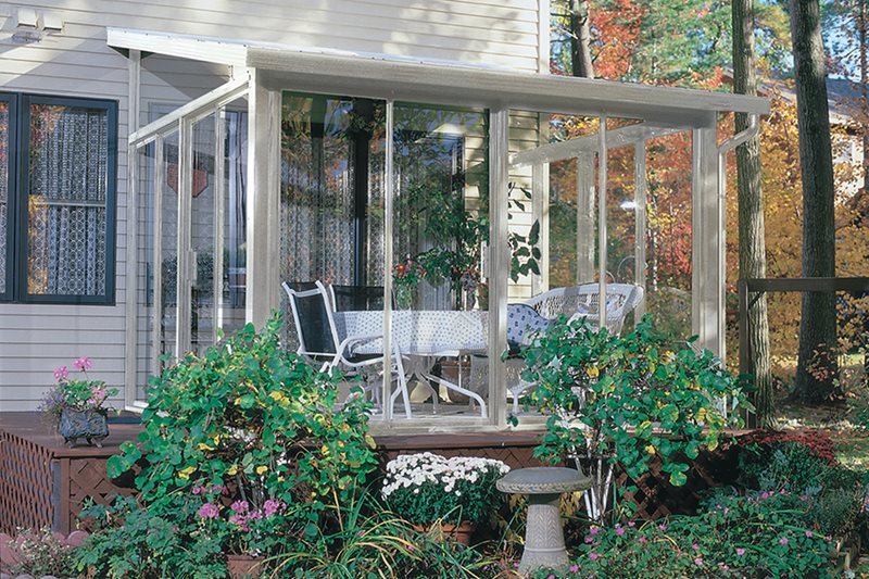 Sunroom that is turned into a greenhouse and has plants inside