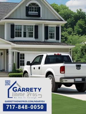 A Garrety Home Pros sign at a house that needs replacement windows